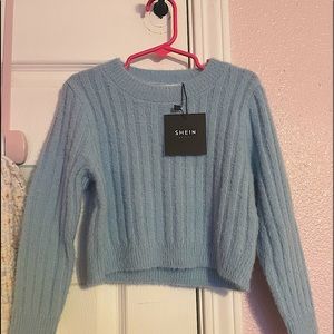 Girl’s light blue sweater